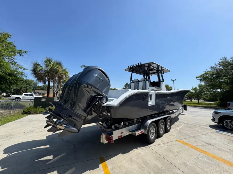 Slide: The Image of 2026 Yellowfin 36 Offshore boat on trailer, parked outdoors under clear blue sky. - 10