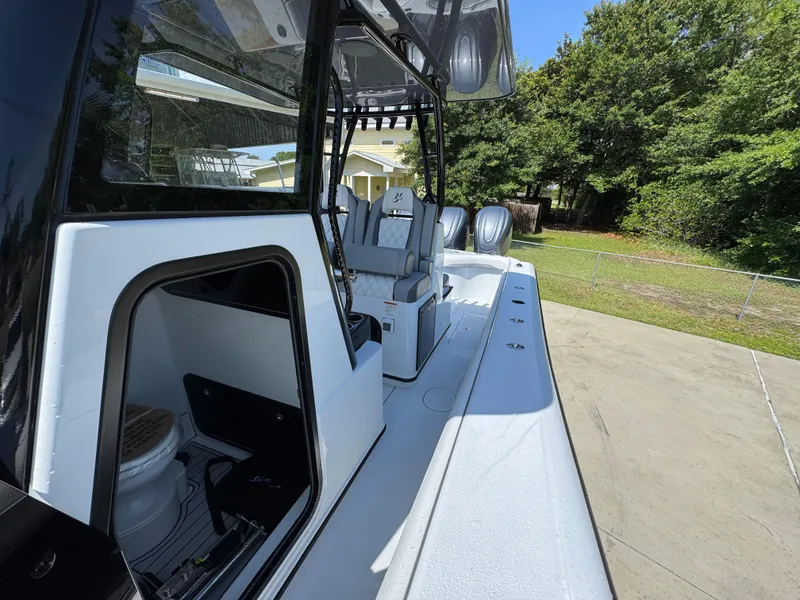 Slide: The Image of 2026 Yellowfin 36 Offshore boat, sleek design, spacious deck, modern amenities, parked outdoors. - 23