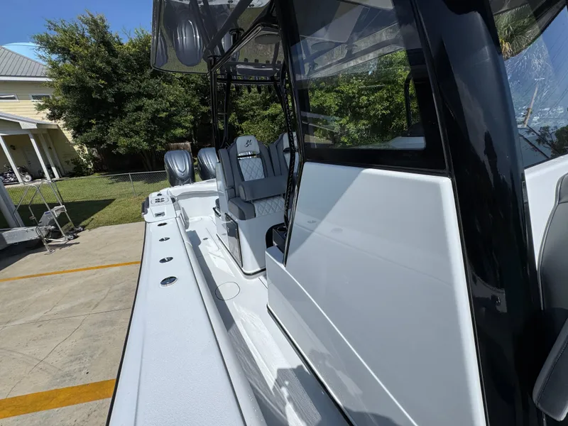 Slide: The Image of 2026 Yellowfin 36 Offshore boat, sleek design, docked outdoors, showcasing modern seating and structure. - 24