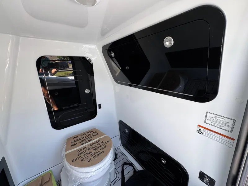 Slide: The Image of Interior of 2026 Yellowfin 36 Offshore boat, featuring sleek black and white design elements. - 27