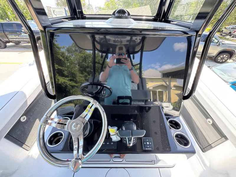 Slide: The Image of 2026 Yellowfin 36 Offshore boat dashboard with steering wheel and controls. - 31