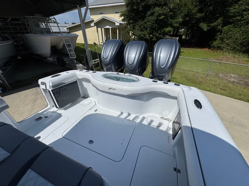 Slide: The Image of 2026 Yellowfin 36 Offshore boat with triple outboard engines, parked outdoors. - 36