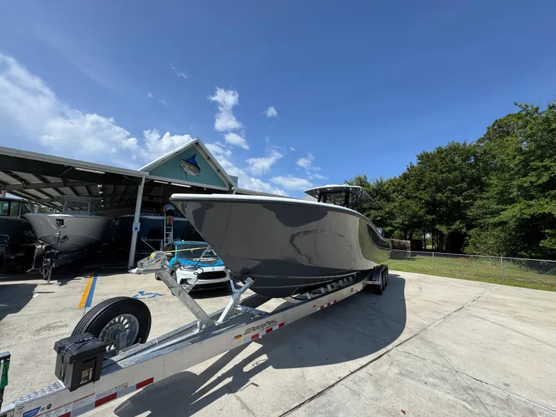 Slide: The Image of 2026 Yellowfin 36 Offshore boat on trailer under clear blue sky. - 4