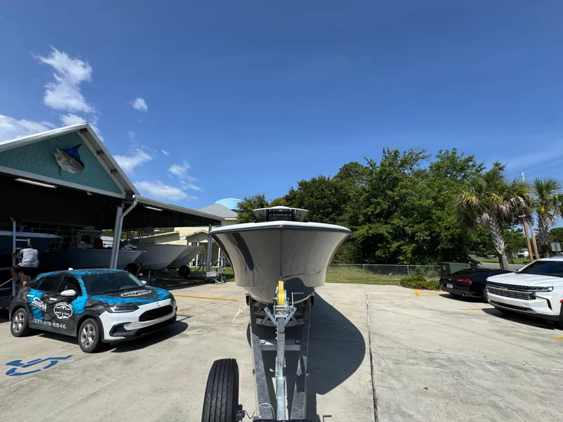 Slide: The Image of 2026 Yellowfin 36 Offshore boat on trailer, parked outdoors under clear blue sky. - 6