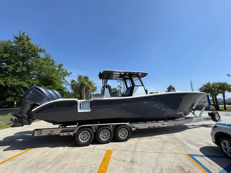 Slide: The Image of 2026 Yellowfin 36 Offshore boat on trailer, parked outdoors under clear blue sky. - 8