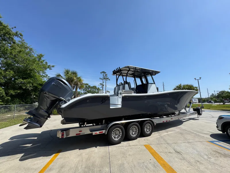 Slide: The Image of 2026 Yellowfin 36 Offshore boat on trailer, parked outdoors under clear blue sky. - 9
