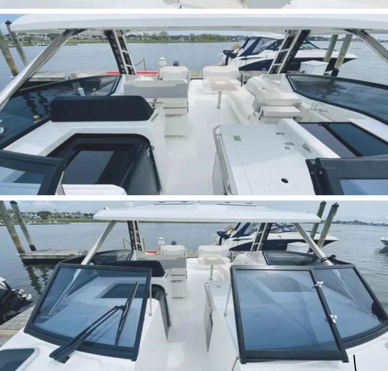 Slide: The Image of 2022 Aquila 32 Sport boat interior with seating and helm, docked by the water. - 5