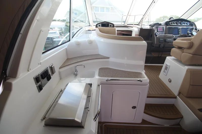 Slide: The Image of Interior of 2013 Cruisers Yachts 430 SC, featuring helm and seating area. - 10