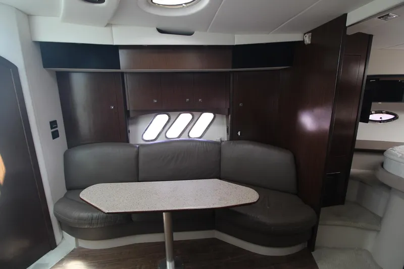 Slide: The Image of Interior of 2013 Cruisers Yachts 430 SC with dark wood and leather seating. - 12