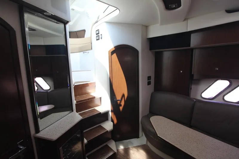 Slide: The Image of Interior of 2013 Cruisers Yachts 430 SC, featuring stairs, seating, and modern design elements. - 13