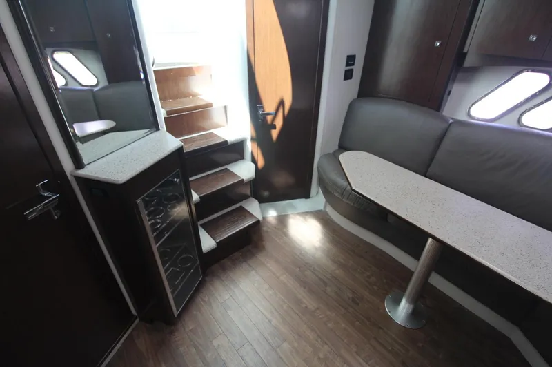 Slide: The Image of Interior of 2013 Cruisers Yachts 430 SC with seating, table, and stairs. - 14