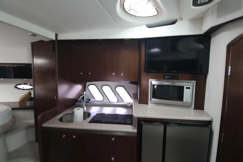 Slide: The Image of 2013 Cruisers Yachts 430 SC kitchen with microwave, sink, and modern appliances. - 16