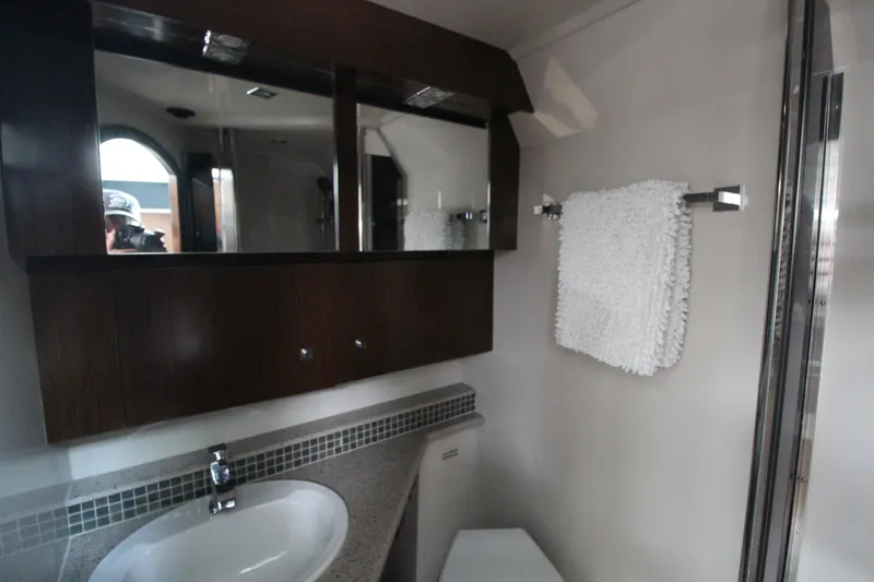 Slide: The Image of 2013 Cruisers Yachts 430 SC bathroom with modern fixtures and dark wood cabinetry. - 19