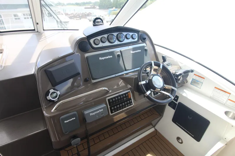 Slide: The Image of Helm of 2013 Cruisers Yachts 430 SC with Raymarine electronics and modern steering wheel. - 3