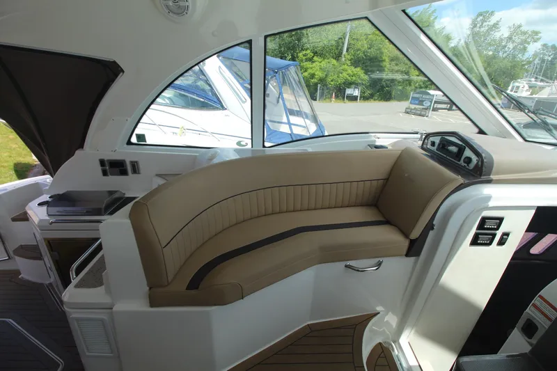 Slide: The Image of 2013 Cruisers Yachts 430 SC interior with beige seating and modern dashboard. - 5