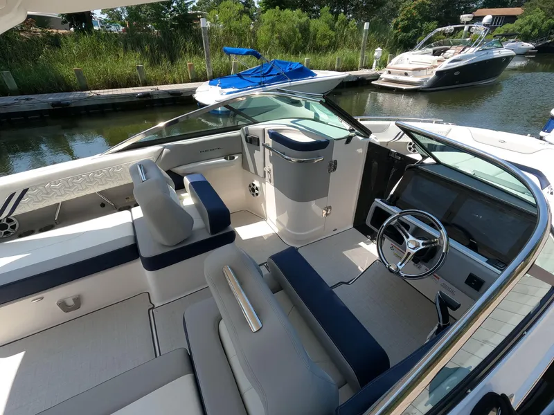 Slide: The Image of 2026 Regal LX6 boat interior with sleek design, modern dashboard, and comfortable seating. - 11