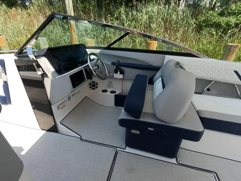 Slide: The Image of 2026 Regal LX6 boat interior with modern dashboard and comfortable seating. - 12