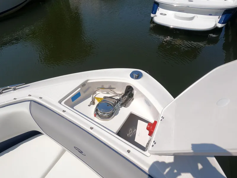 Slide: The Image of 2026 Regal LX6 boat anchor compartment open, showing anchor and storage details. - 19