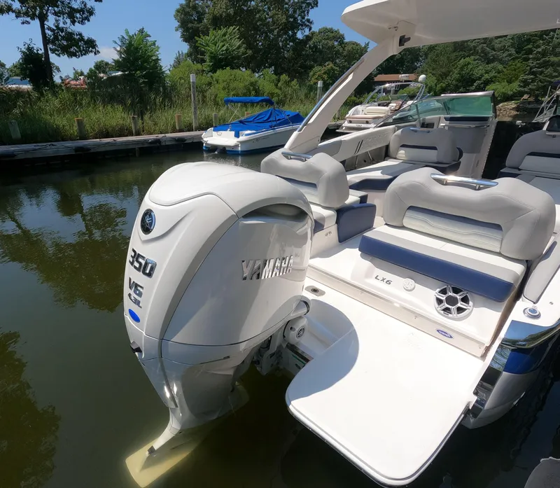 Slide: The Image of 2026 Regal LX6 boat with Yamaha 350 V6 engine docked by the water. - 2