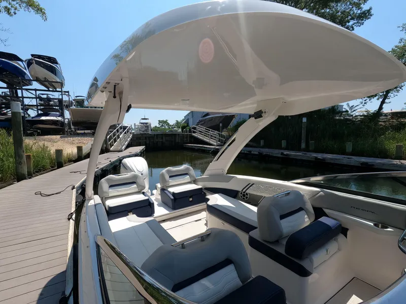 Slide: The Image of 2026 Regal LX6 boat interior at dock, featuring sleek seating and modern design. - 22