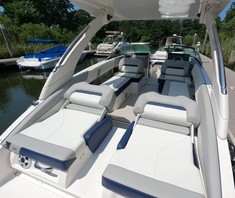 Slide: The Image of 2026 Regal LX6 boat interior with luxurious seating and sleek design at a marina. - 4