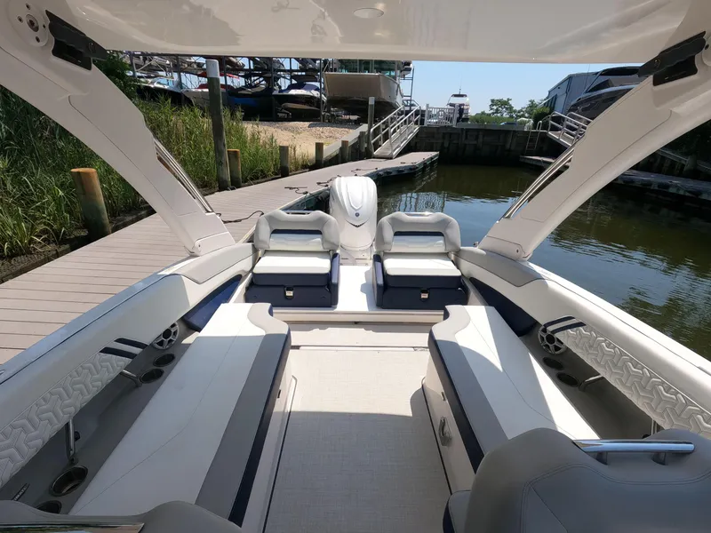 Slide: The Image of 2026 Regal LX6 boat interior with luxurious seating and modern design at a dock. - 7