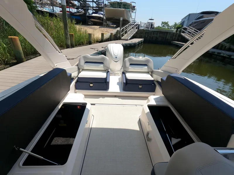 Slide: The Image of 2026 Regal LX6 boat interior at dock, featuring spacious seating and storage compartments. - 8
