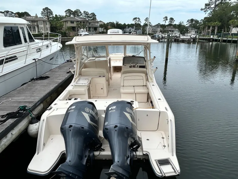 Slide: The Image of 2018 Grady-White Freedom 325 boat docked with twin Yamaha engines. - 1