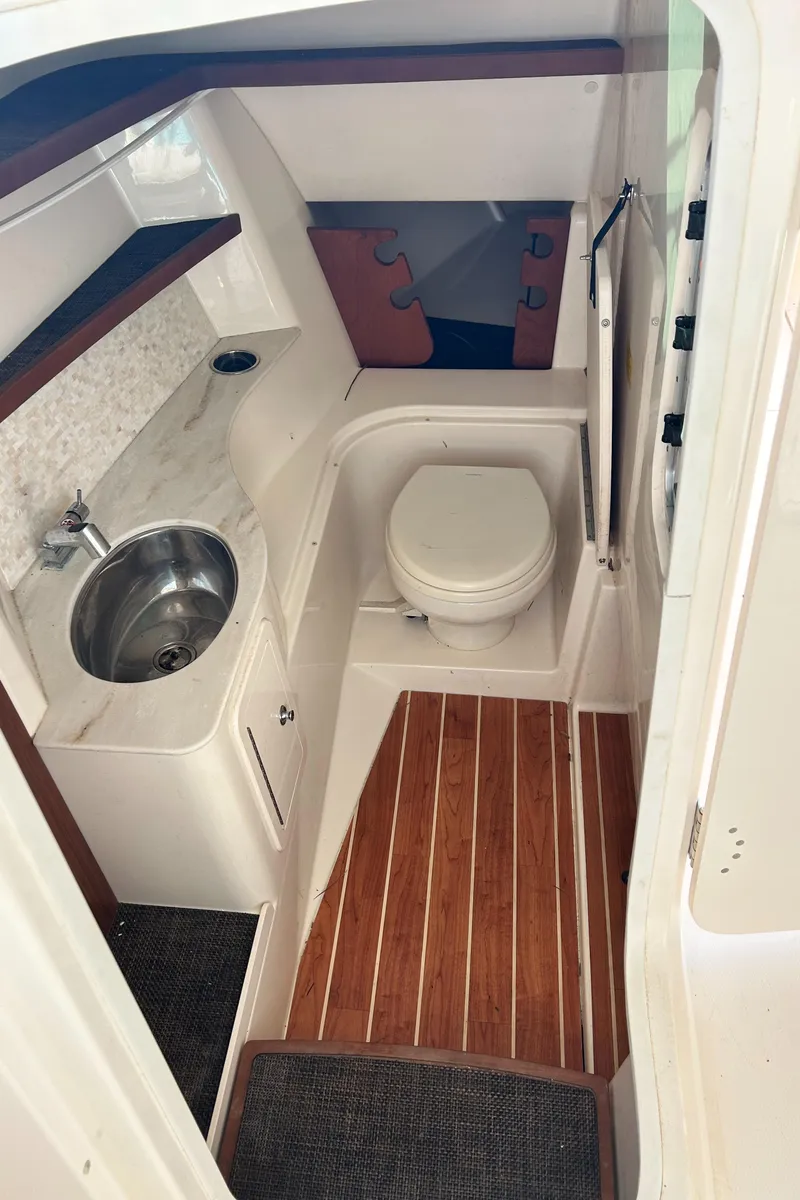 Slide: The Image of 2018 Grady-White Freedom 325 boat interior with sink and toilet. - 11