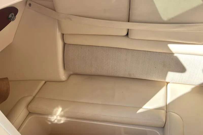 Slide: The Image of 2018 Grady-White Freedom 325 interior seating with beige upholstery and sunlight. - 12