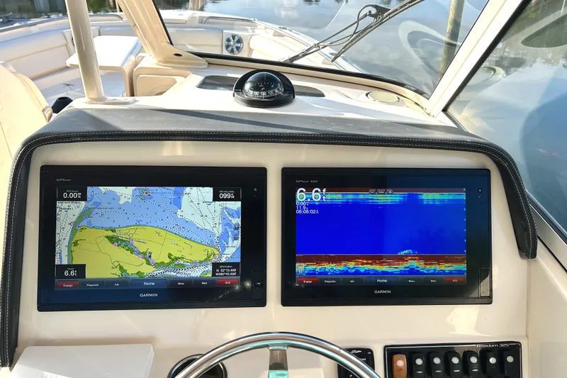 Slide: The Image of Dashboard of 2018 Grady-White Freedom 325 boat with navigation and sonar displays. - 15