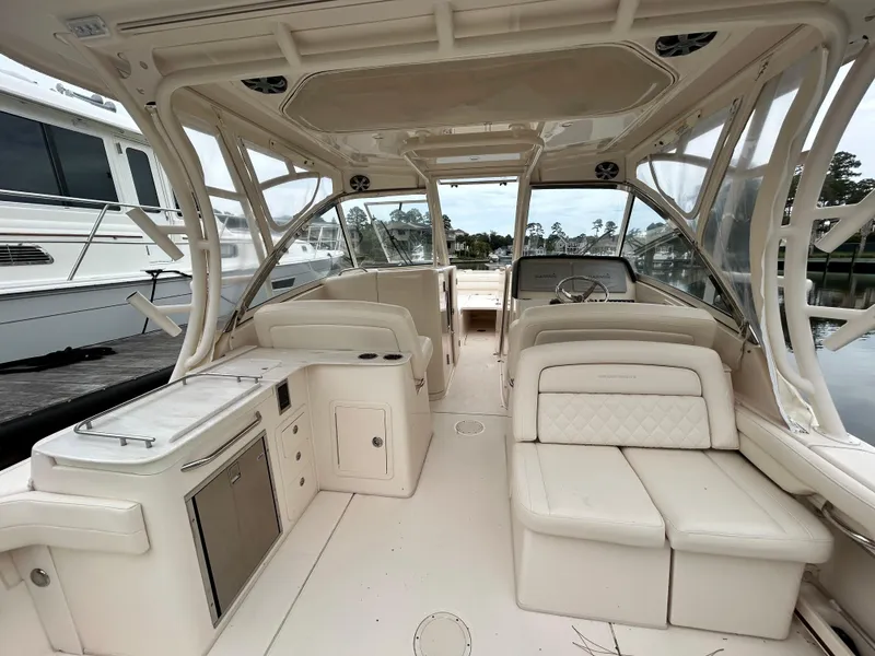 Slide: The Image of 2018 Grady-White Freedom 325 boat interior with seating and helm, docked at marina. - 3