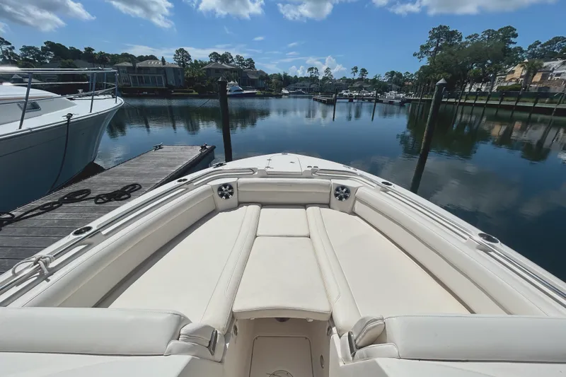 Slide: The Image of 2018 Grady-White Freedom 325 boat docked in a serene marina setting. - 4