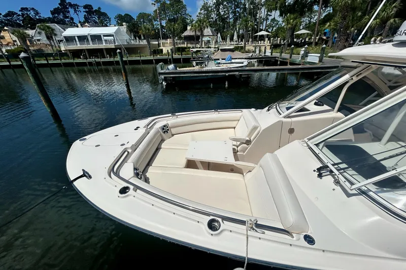 Slide: The Image of 2018 Grady-White Freedom 325 boat docked in a serene marina setting. - 6