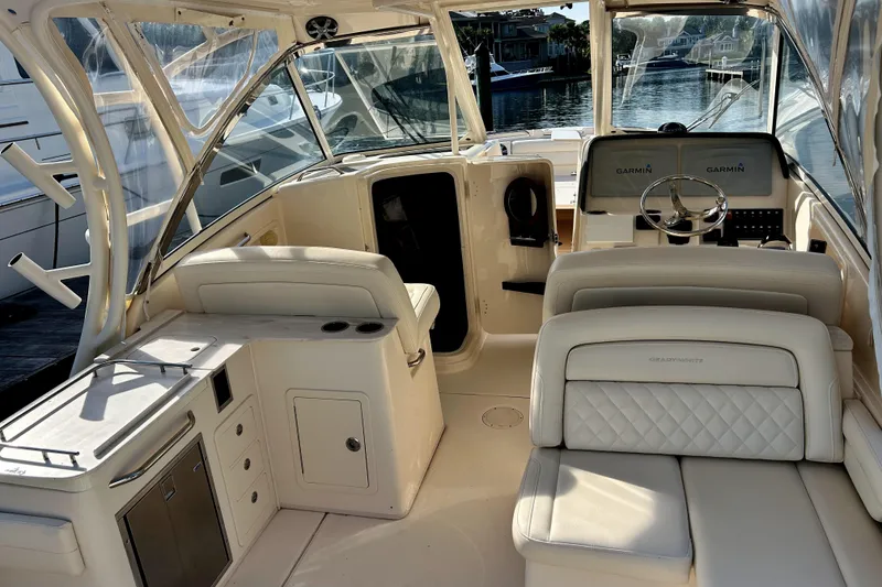 Slide: The Image of 2018 Grady-White Freedom 325 boat interior with luxurious seating and helm. - 8