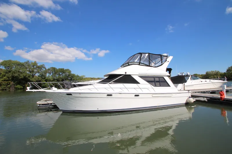 Slide: The Image of 1996 Bayliner 3988 Command Bridge Motoryacht docked on a sunny day. - 1