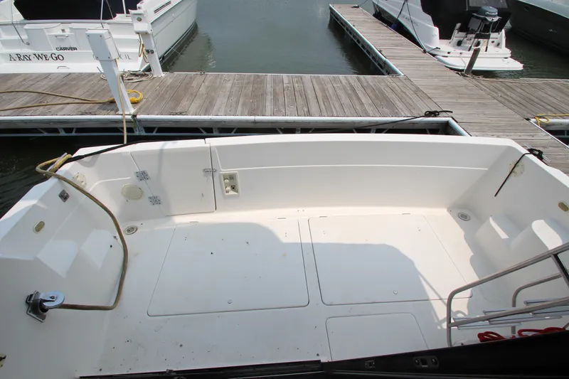 Slide: The Image of 1996 Bayliner 3988 Command Bridge Motoryacht docked, showing spacious deck area. - 11