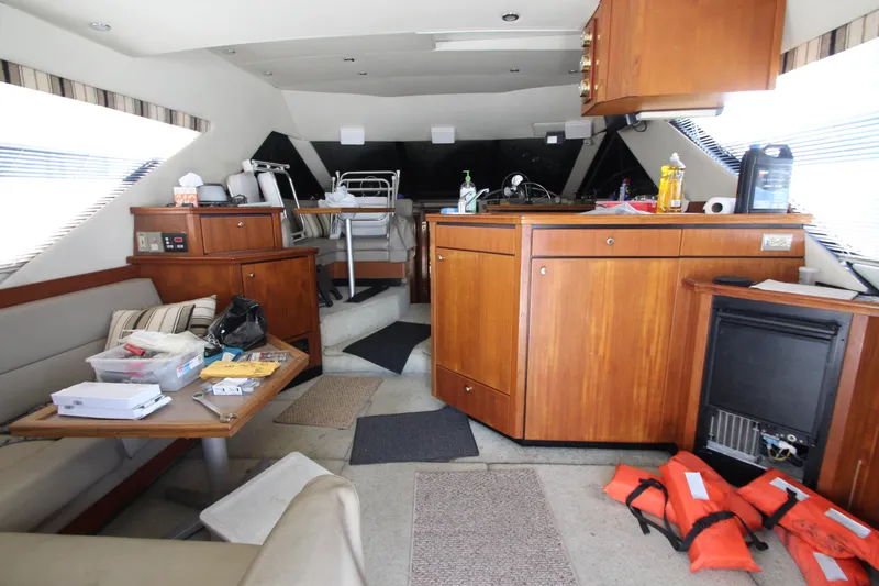 Slide: The Image of Interior of 1996 Bayliner 3988 Command Bridge Motoryacht with wood cabinetry and seating area. - 17
