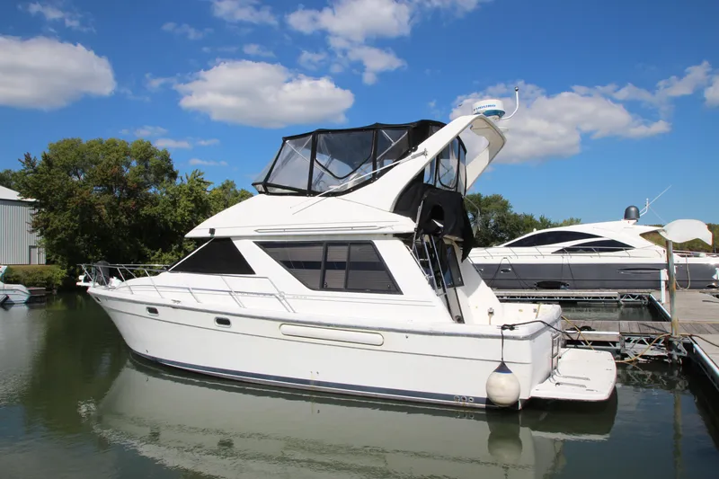 Slide: The Image of 1996 Bayliner 3988 Command Bridge Motoryacht docked on a sunny day. - 2