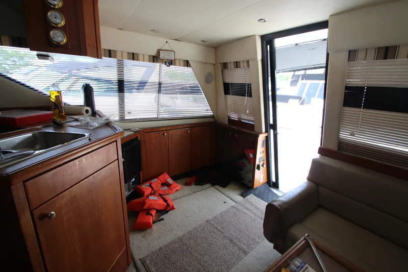 Slide: The Image of Interior of 1996 Bayliner 3988 Command Bridge Motoryacht with kitchen and seating area. - 21