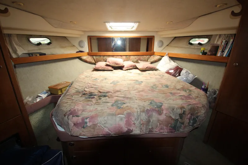 Slide: The Image of Cozy bedroom in 1996 Bayliner 3988 Command Bridge Motoryacht with plush bedding and ambient lighting. - 25