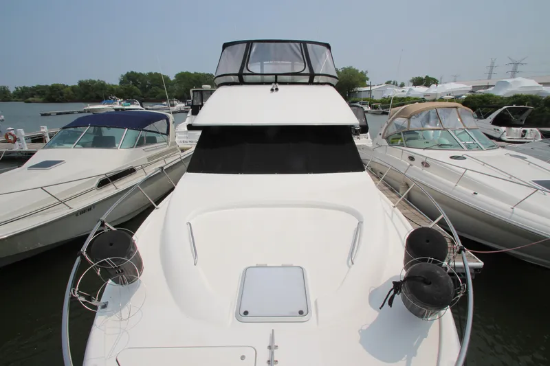 Slide: The Image of 1996 Bayliner 3988 Command Bridge Motoryacht docked among other boats. - 7