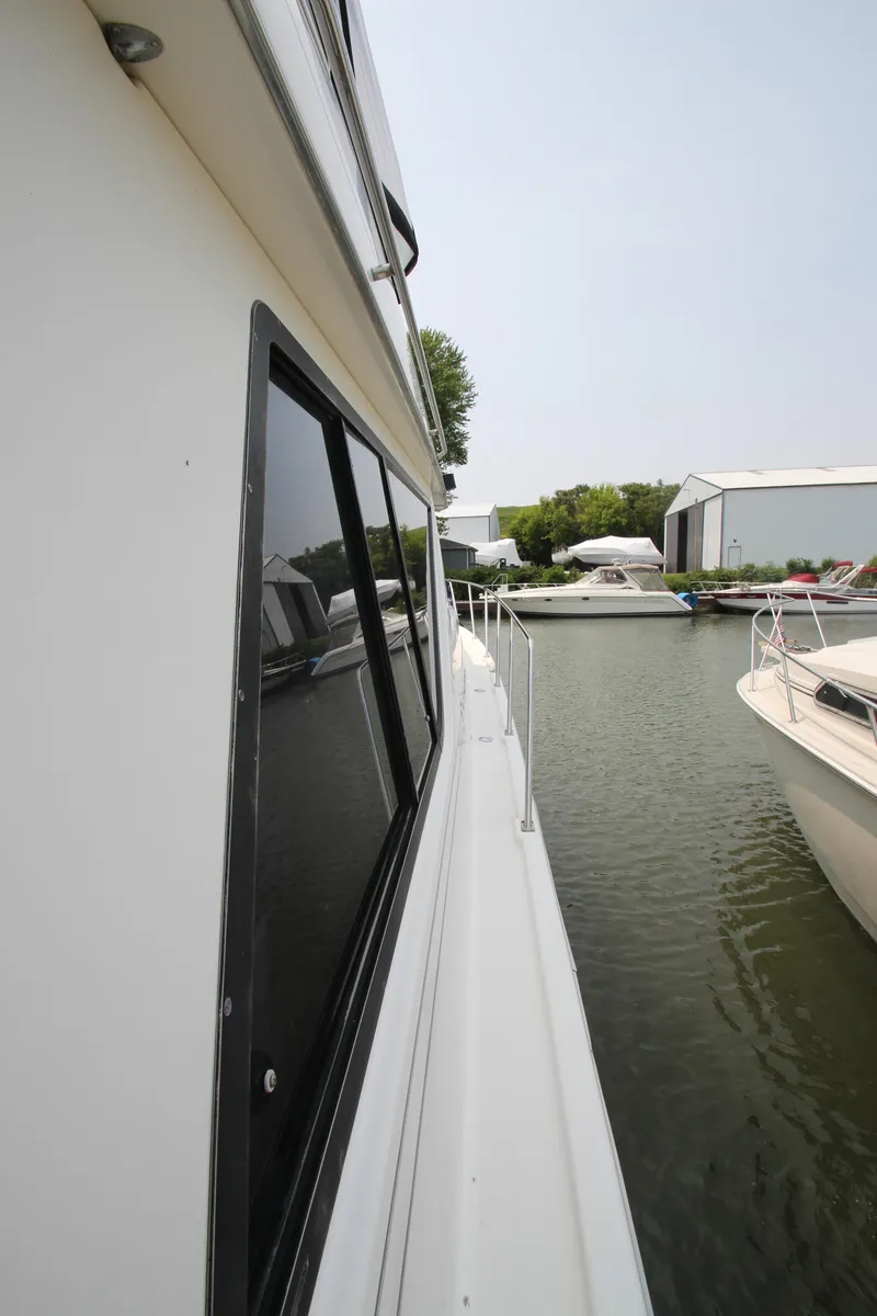 Slide: The Image of 1996 Bayliner 3988 Command Bridge Motoryacht docked in a marina. - 9
