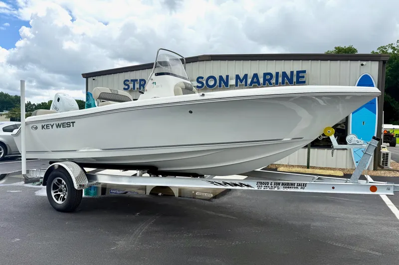 The Image of 2025 Key West 189 FS boat on trailer at dealership, cloudy sky background. - 1