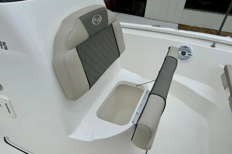 Slide: The Image of 2025 Key West 189 FS boat seat with storage compartment, featuring gray and beige upholstery. - 13