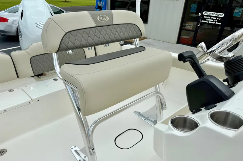 Slide: The Image of 2025 Key West 189 FS boat seat with cup holders and steering controls. - 15