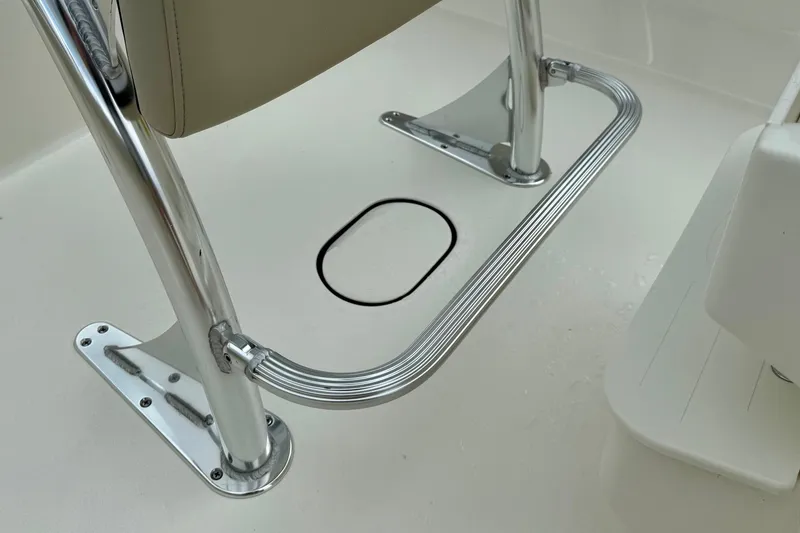 Slide: The Image of Key West 189 FS 2025 boat seat with chrome footrest and white deck. - 16