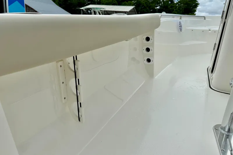 Slide: The Image of 2025 Key West 189 FS boat interior, showcasing sleek white design and rod holders. - 19