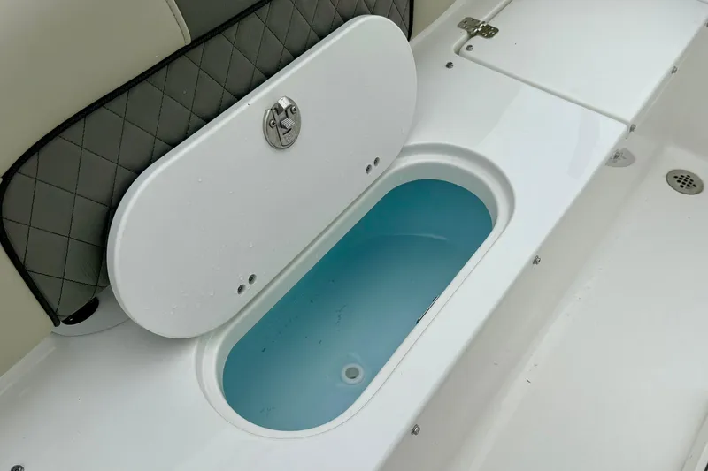 Slide: The Image of 2025 Key West 189 FS boat storage compartment with open lid, showcasing interior design. - 23