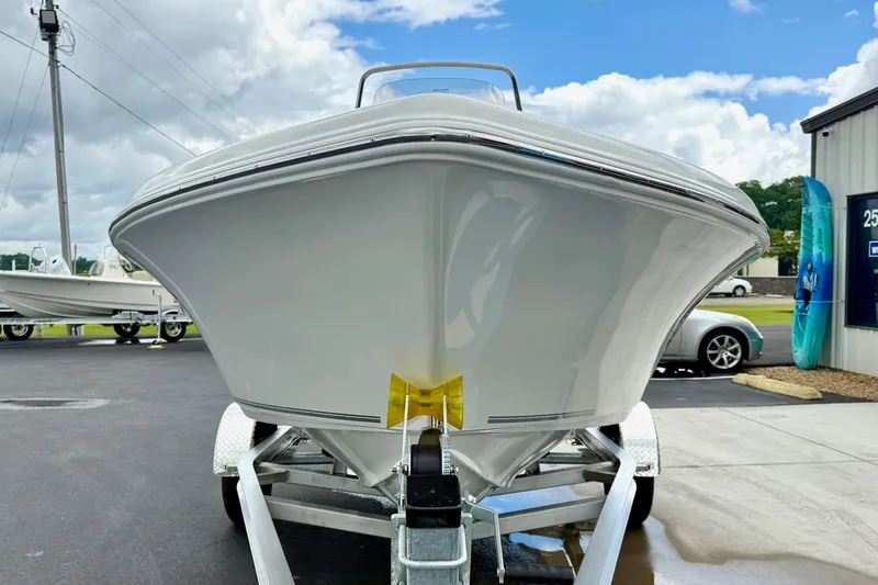 Slide: The Image of 2025 Key West 189 FS boat on trailer, parked outdoors under cloudy sky. - 7